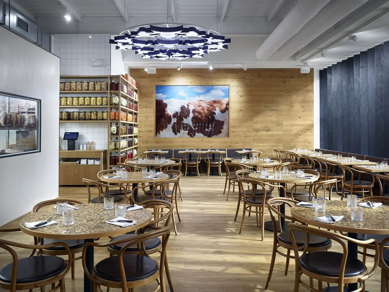 Interior of Čestr restaurant with wooden furniture and an open dining space.
